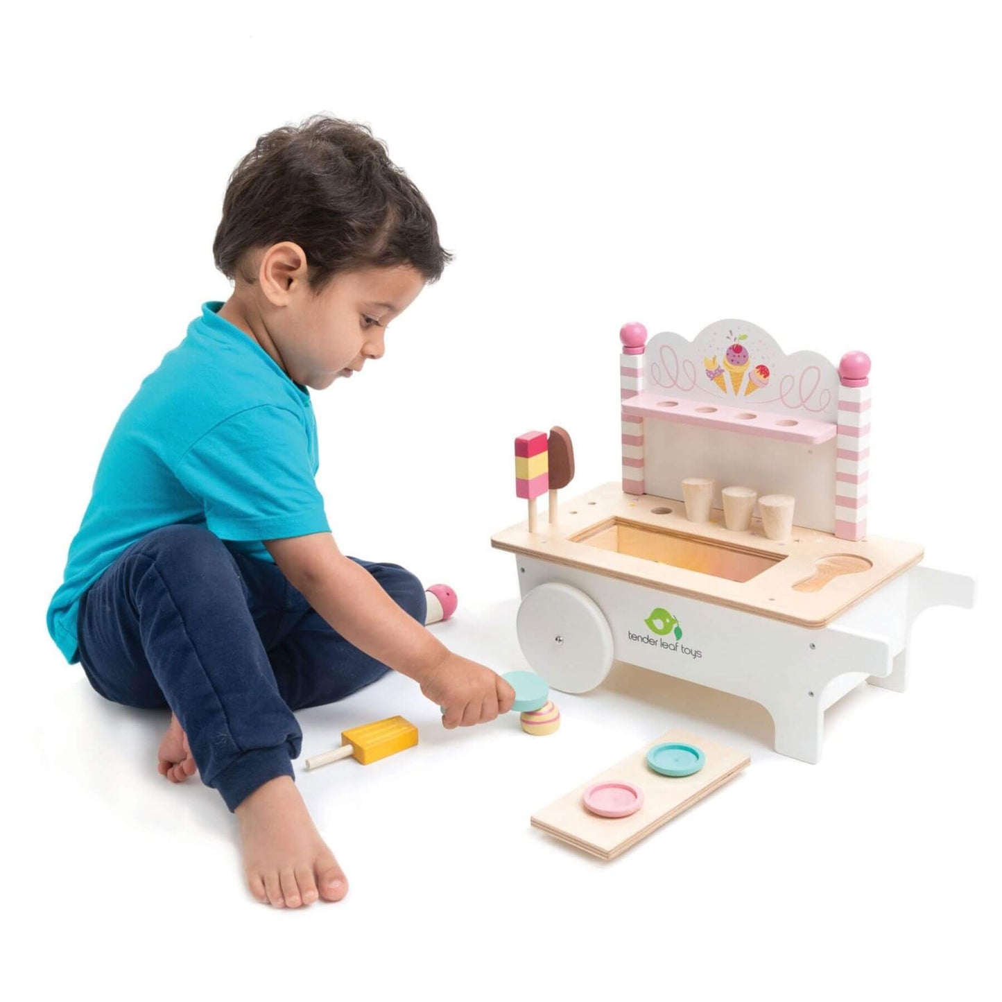 Child playing with Tender Leaf Ice Cream Cart on a white background