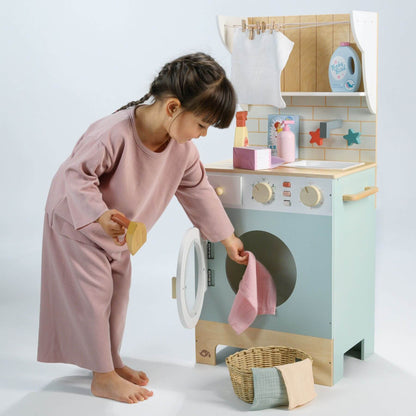 Child playing with Tender Leaf Laundrette
