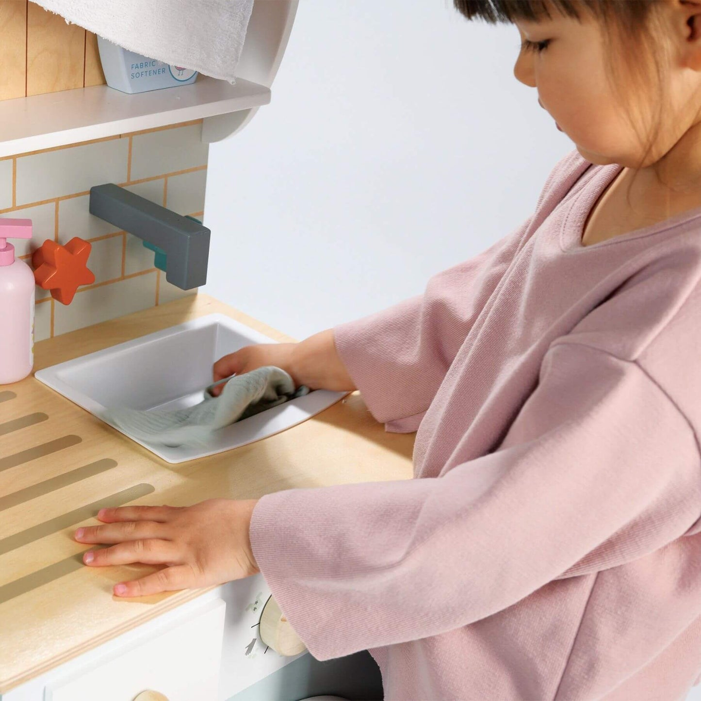 Child washing Cloth in Tender Leaf Laundrette