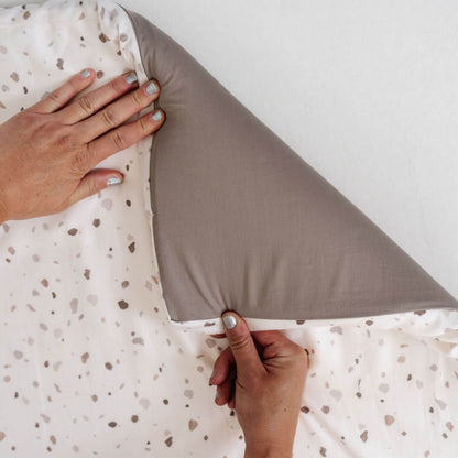 Person holding Terrazzo Chalk Organic Cotton Mat