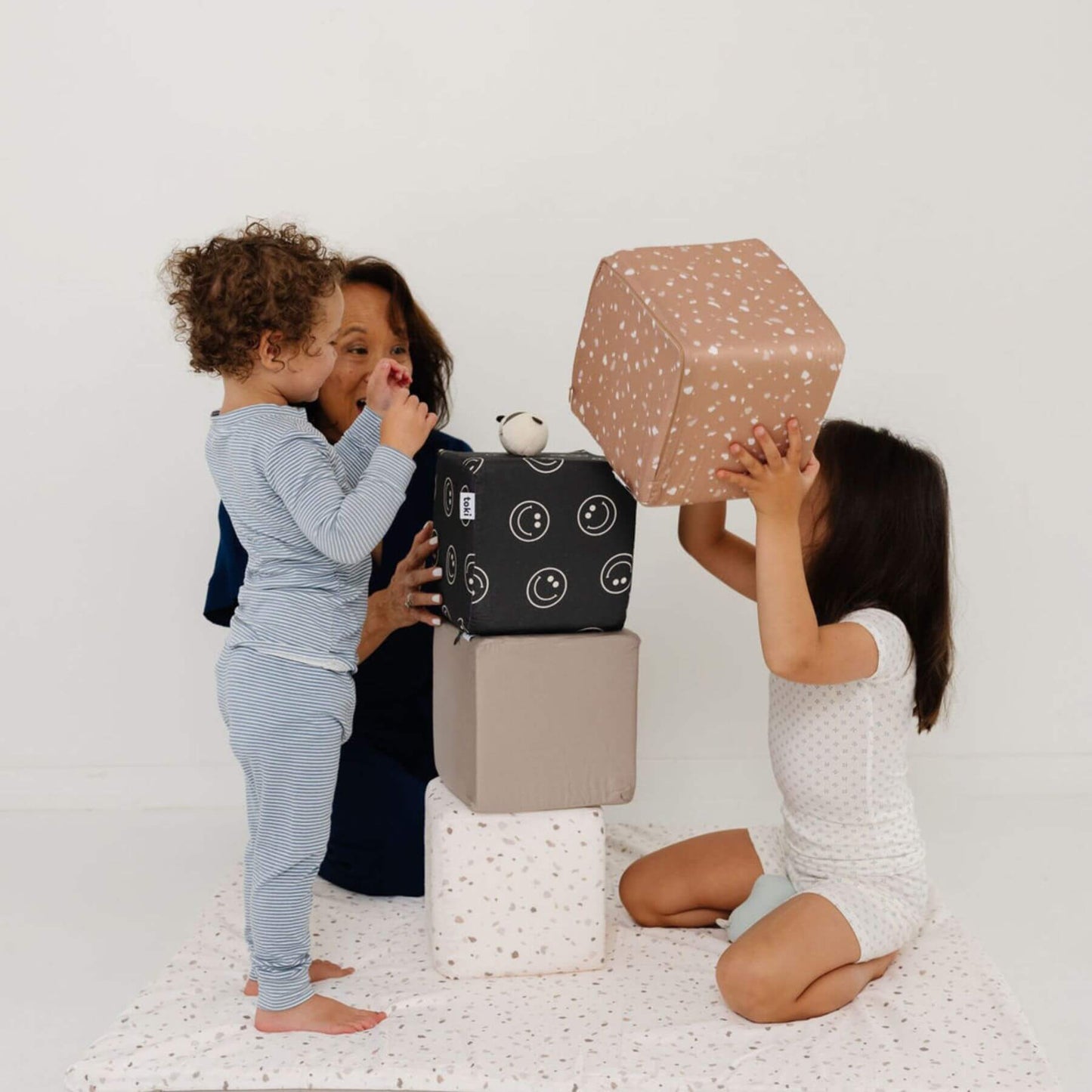 Woman and kids playing with Toki Kids Play Cubes