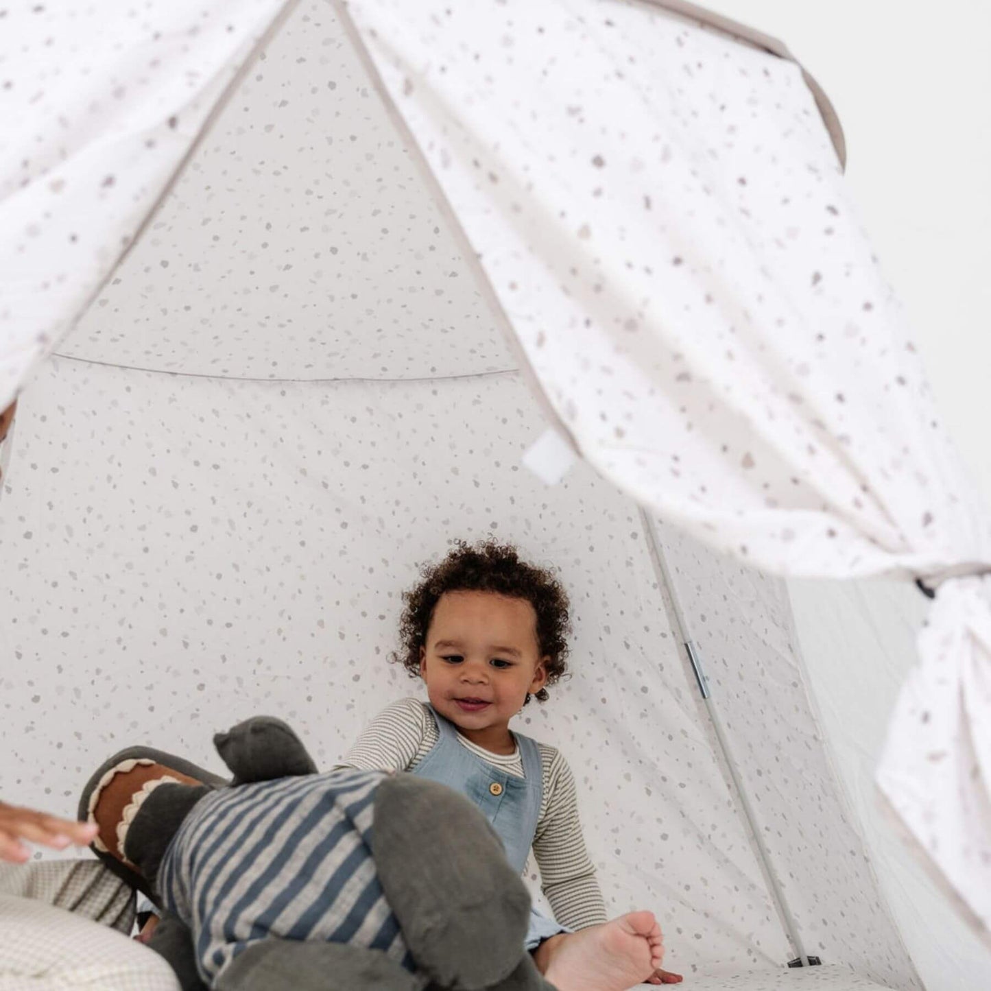 Kid playing inside Toki Kids Terrazzo Chalk Play Tent
