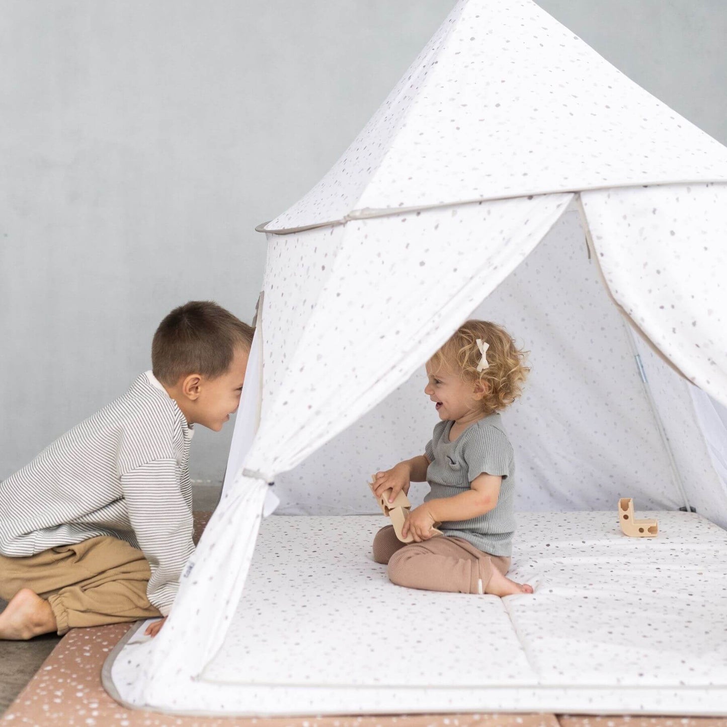 Kids playing inside Toki Kids Terrazzo Chalk Play Tent