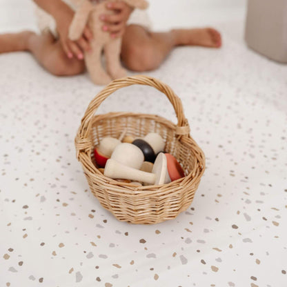 A basket with toys on Toki Kids Terrazzo Chalk Vegan Leather Mat