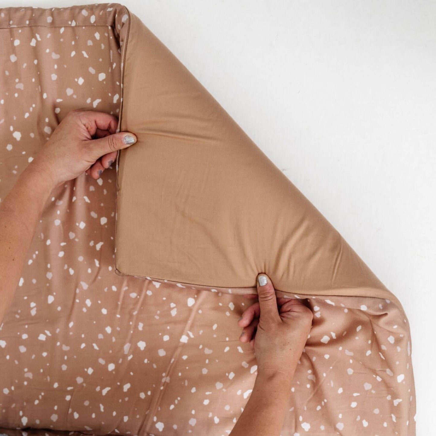 Person holding Terrazzo Clay Organic Cotton Mat