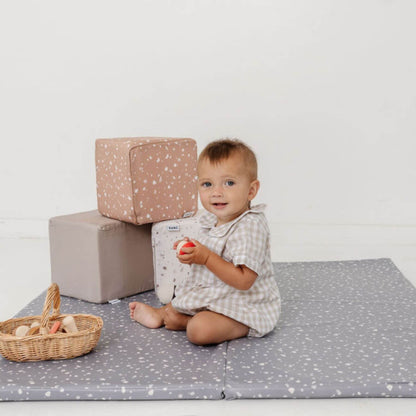 Baby sitting on play mat with Toki Kids Play Cubes