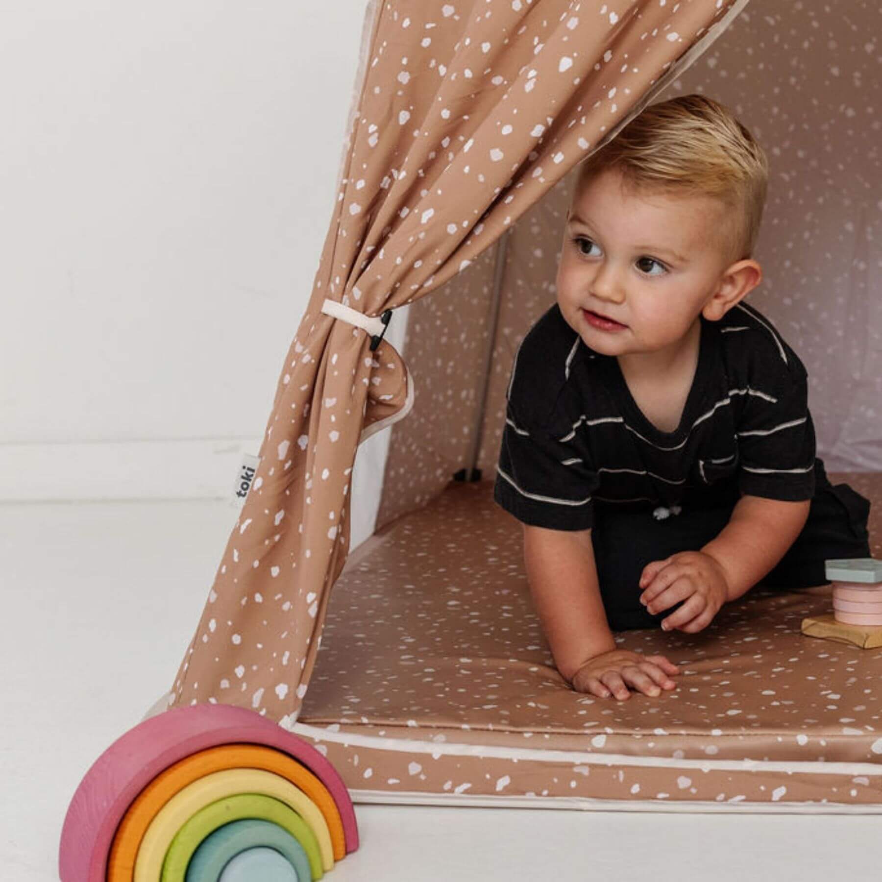 Kid playing inside Toki Kids Terrazzo Clay Play Tent