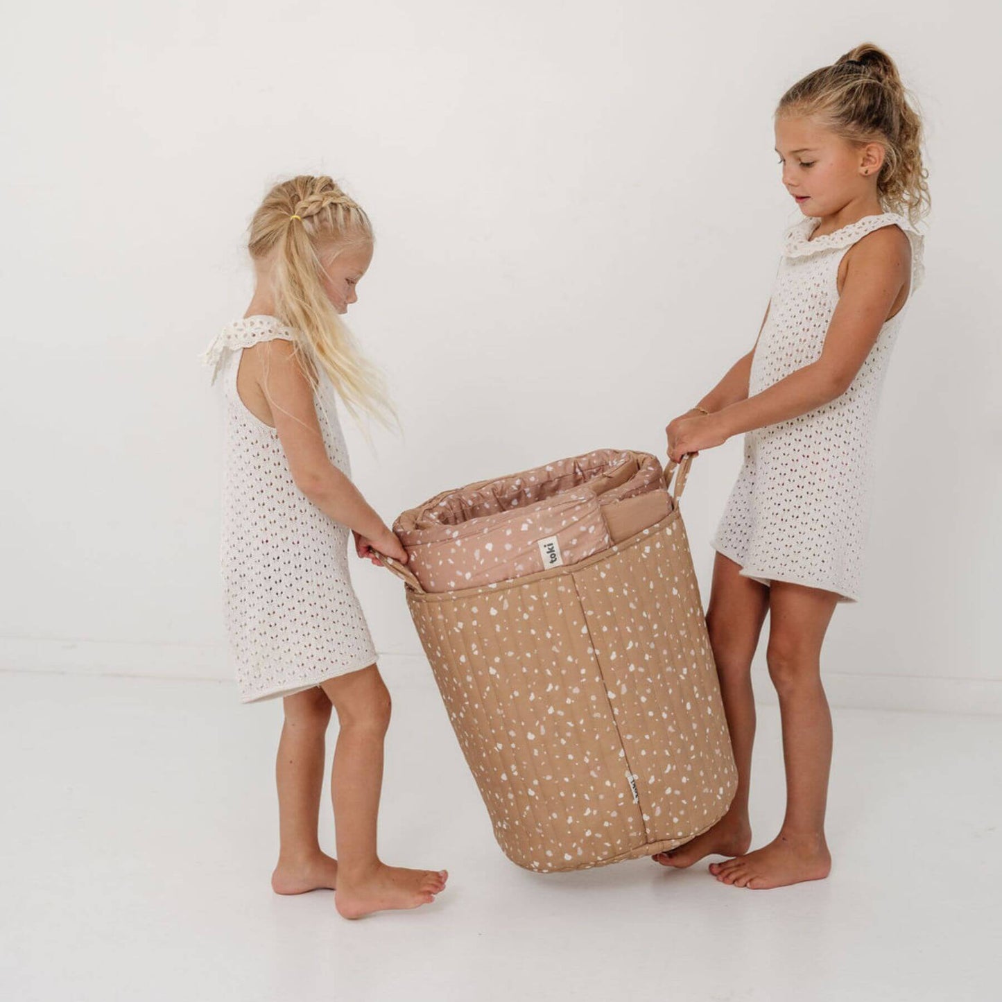Two children holding Terrazzo Clay Storage Basket