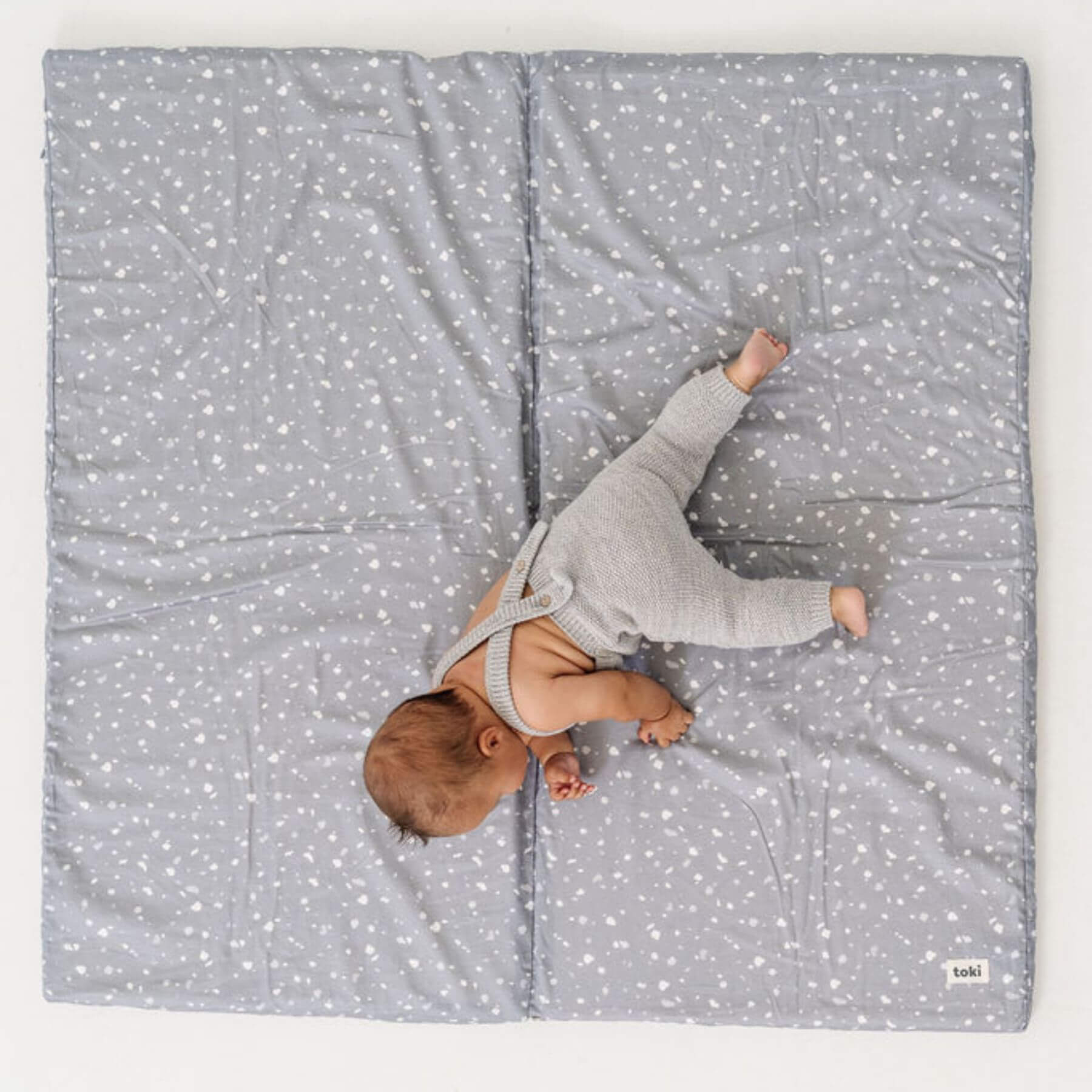 Baby lying on Terrazzo Slate Organic Cotton Mat