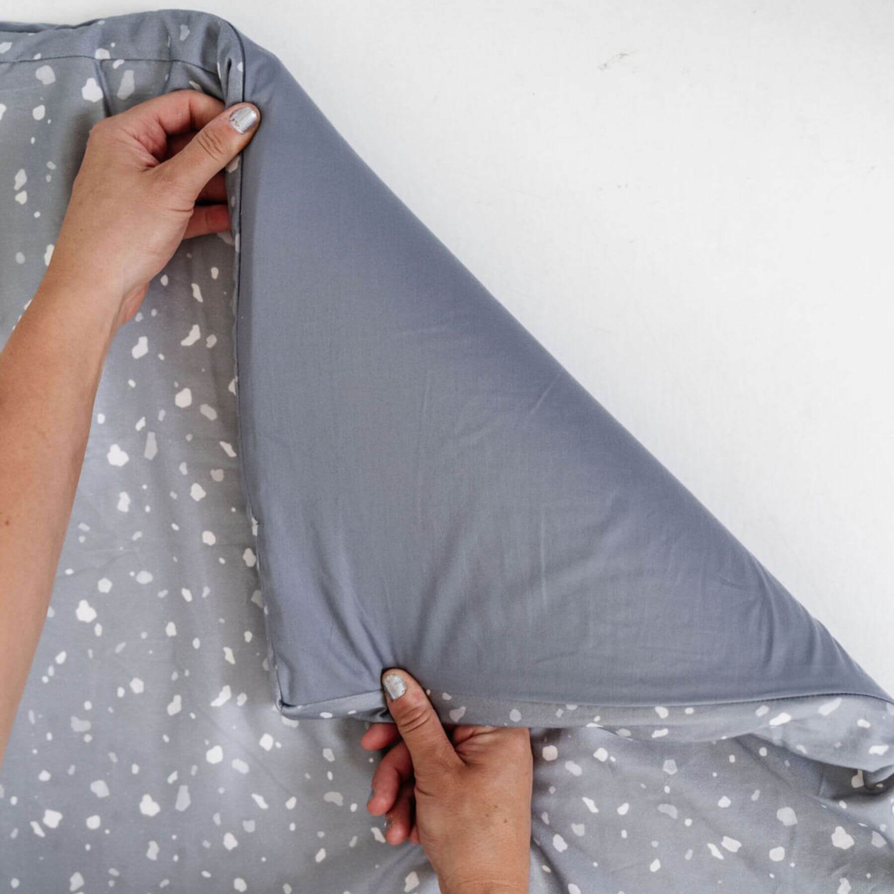 Person holding Terrazzo Slate Organic Cotton Mat