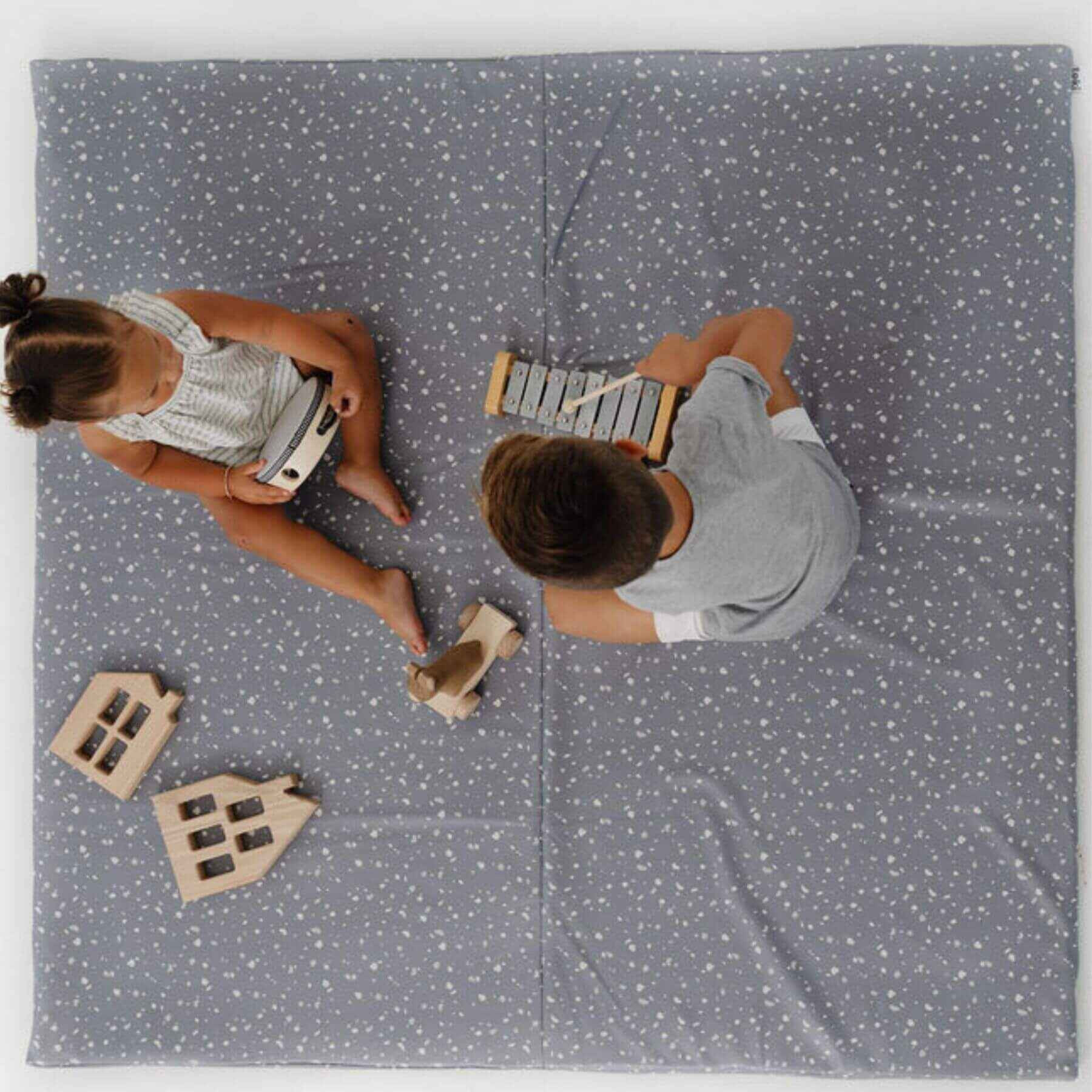 Two Kids playing on Toki Kids Terrazzo Slate Vegan Leather Mat