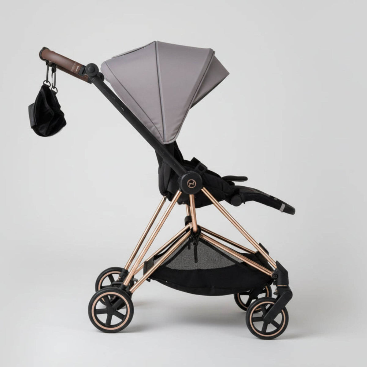 Modern baby stroller with The Stroller Sling - All Weather on a white background