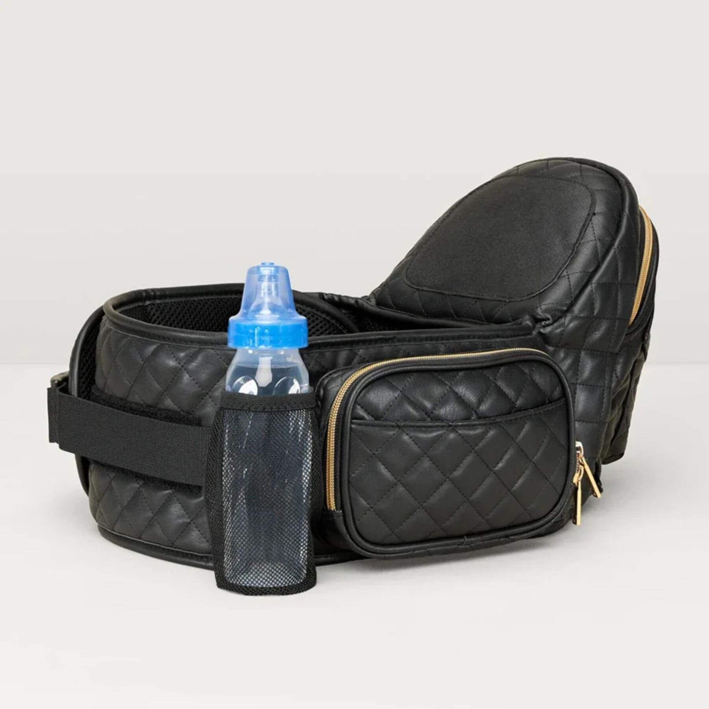 The Tushbaby Hip Carrier - Black/Gold with a blue bottle