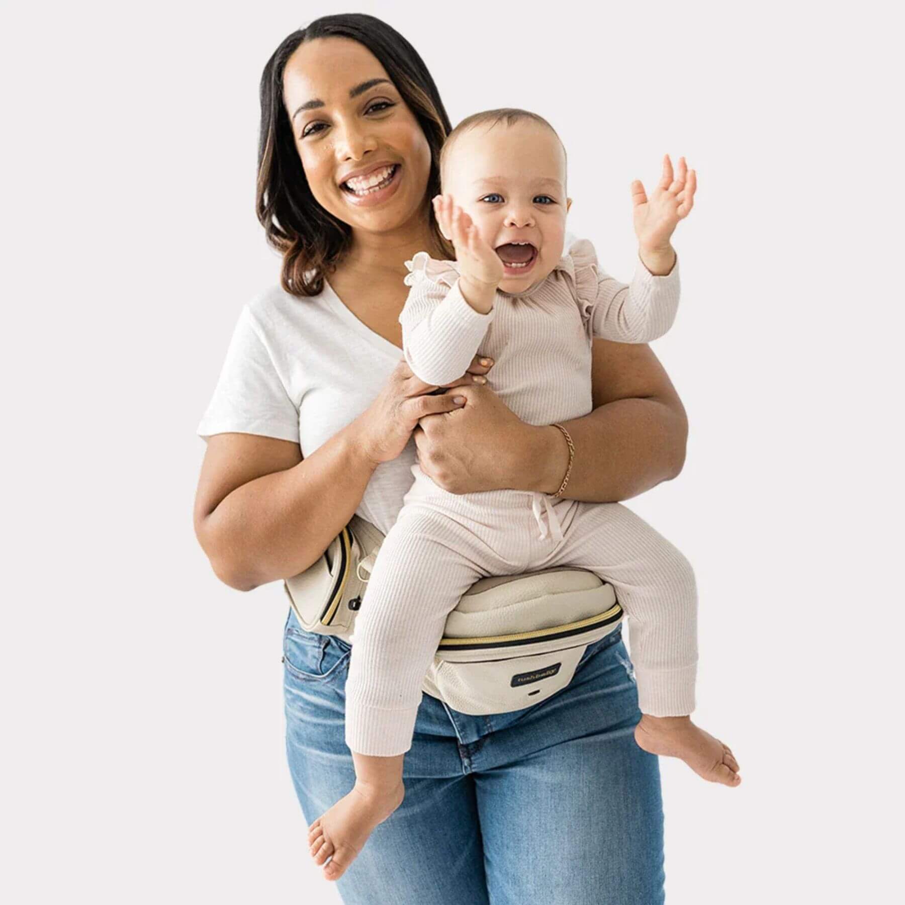 Woman holding a baby using The Tushbaby Hip Carrier - Cream