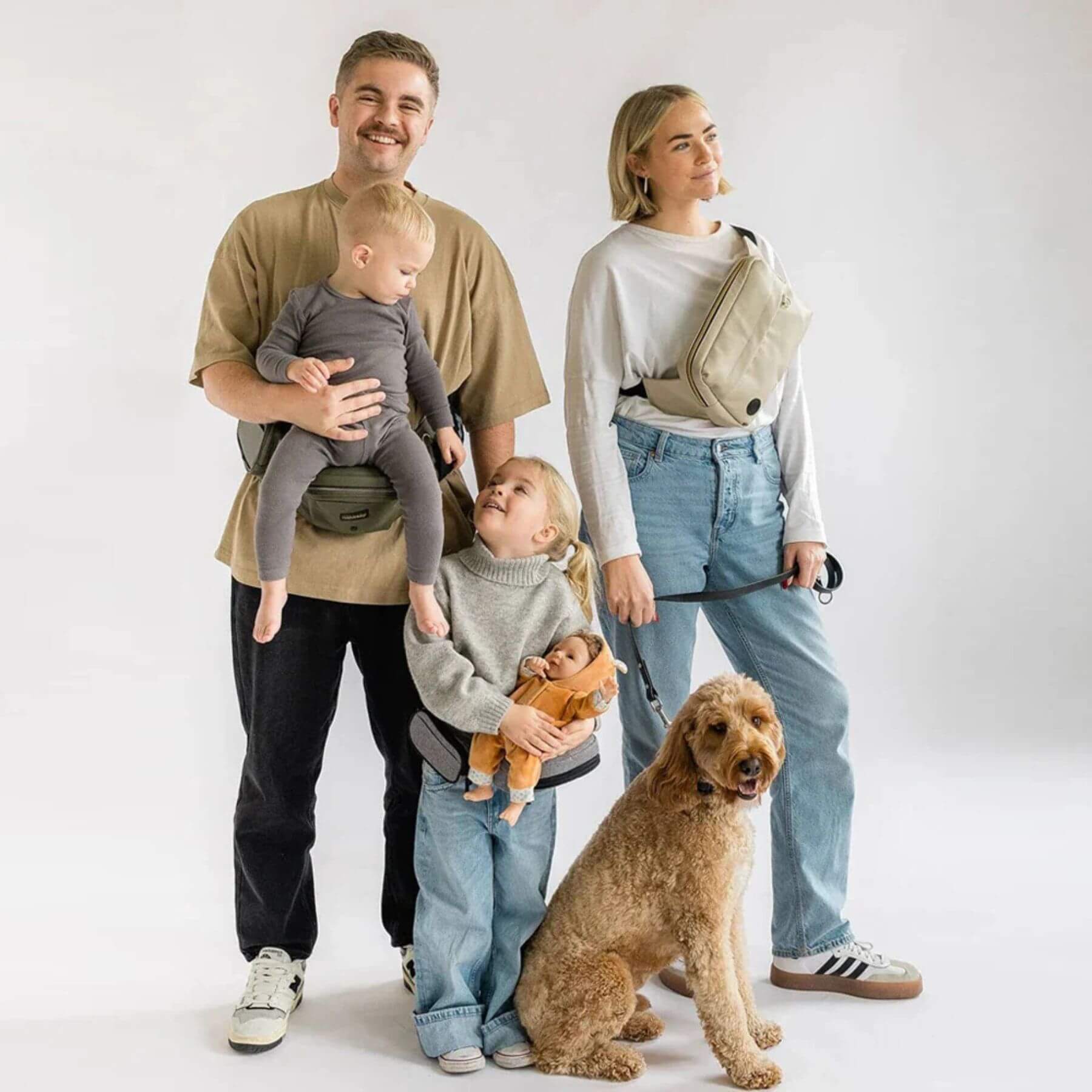 Family of four with two children and a dog on a white background