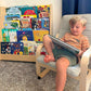 Boy Reading next to RAD Children's Furniture Tiered Montessori Bookshelf