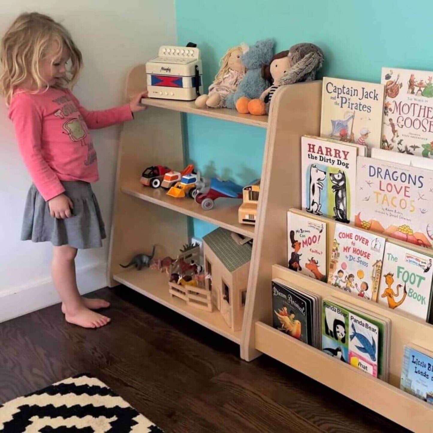 Girl Standing next to RAD Children's Furniture Tiered Montessori Bookshelf