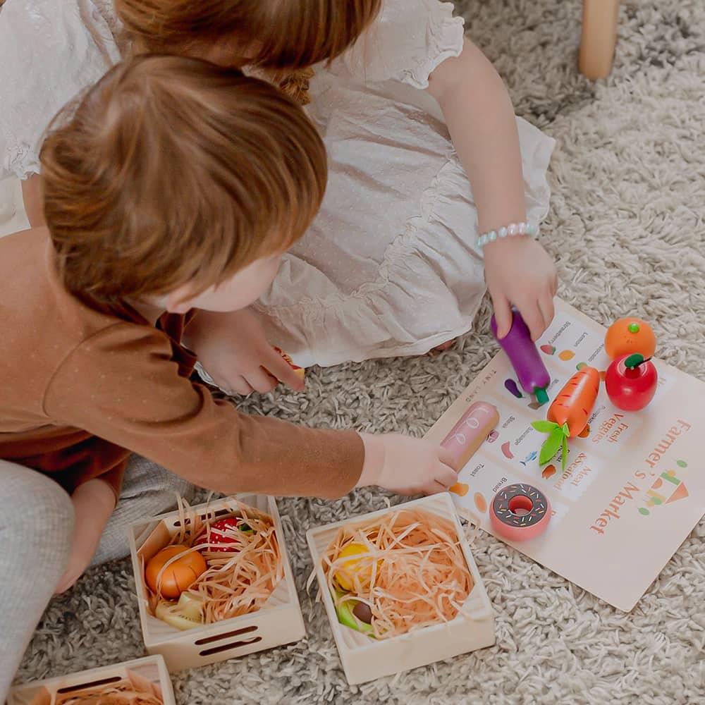 Kids Playing Tiny Land® Wooden Play Food on a rug