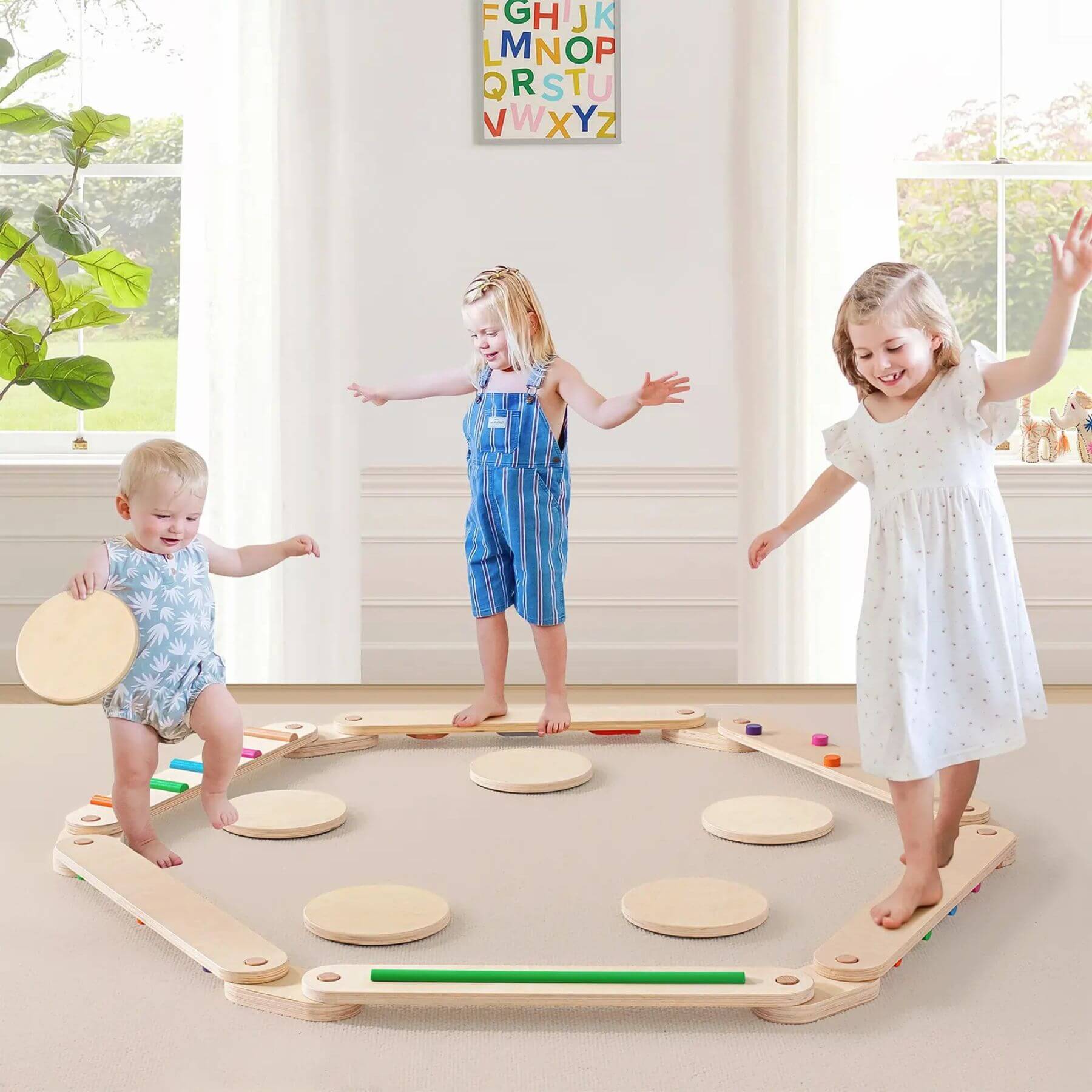 Three children playing with Tiny Land® Balance Beam in a bright room.