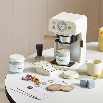 Tiny Land® Children’s Coffee Maker on a table with coffee-related items
