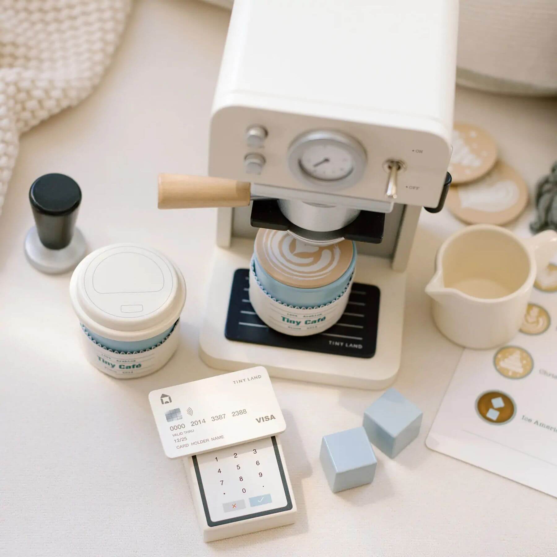 Tiny Land® Children’s Coffee Maker on a light surface with a card and small cubes.