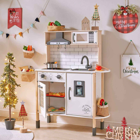 Tiny Land® Interactive Play Kitchen with Sounds & Cookware with Christmas decorations in a room.