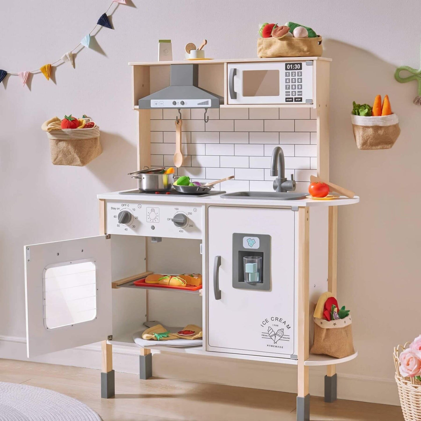 Tiny Land® Interactive Play Kitchen with Sounds & Cookware with various accessories in a room setting.