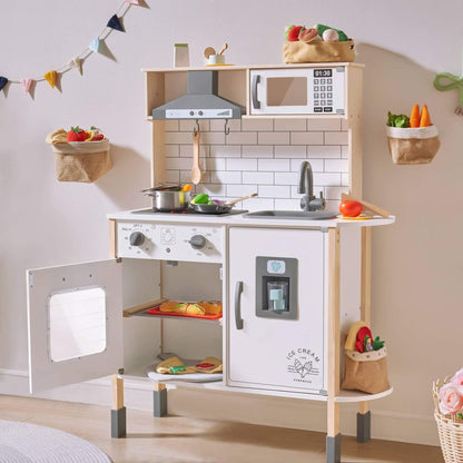 Tiny Land® Interactive Play Kitchen with Sounds & Cookware with various accessories in a room setting.