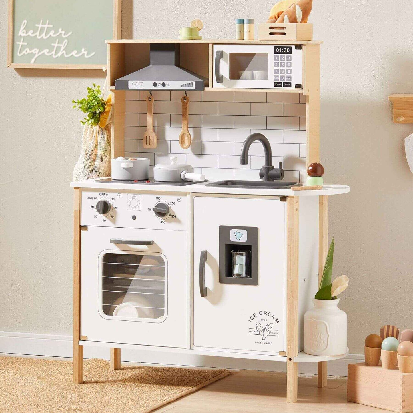 Tiny Land® Interactive Play Kitchen with Sounds & Cookware against a light-colored wall.