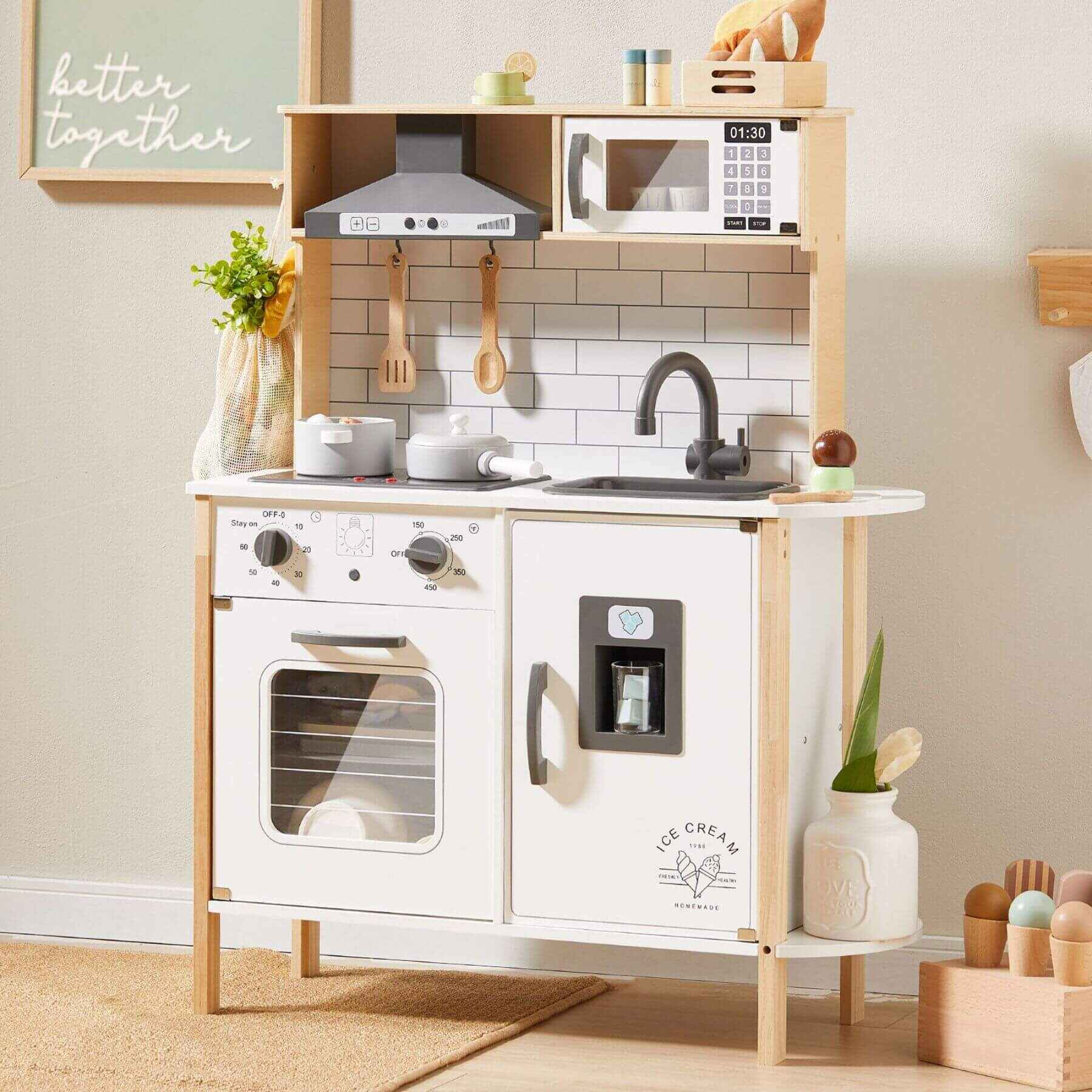 Tiny Land® Interactive Play Kitchen with Sounds & Cookware against a light-colored wall.