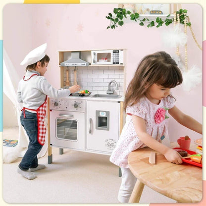Two children playing with Tiny Land® Interactive Play Kitchen with Sounds & Cookware in a decorated room.