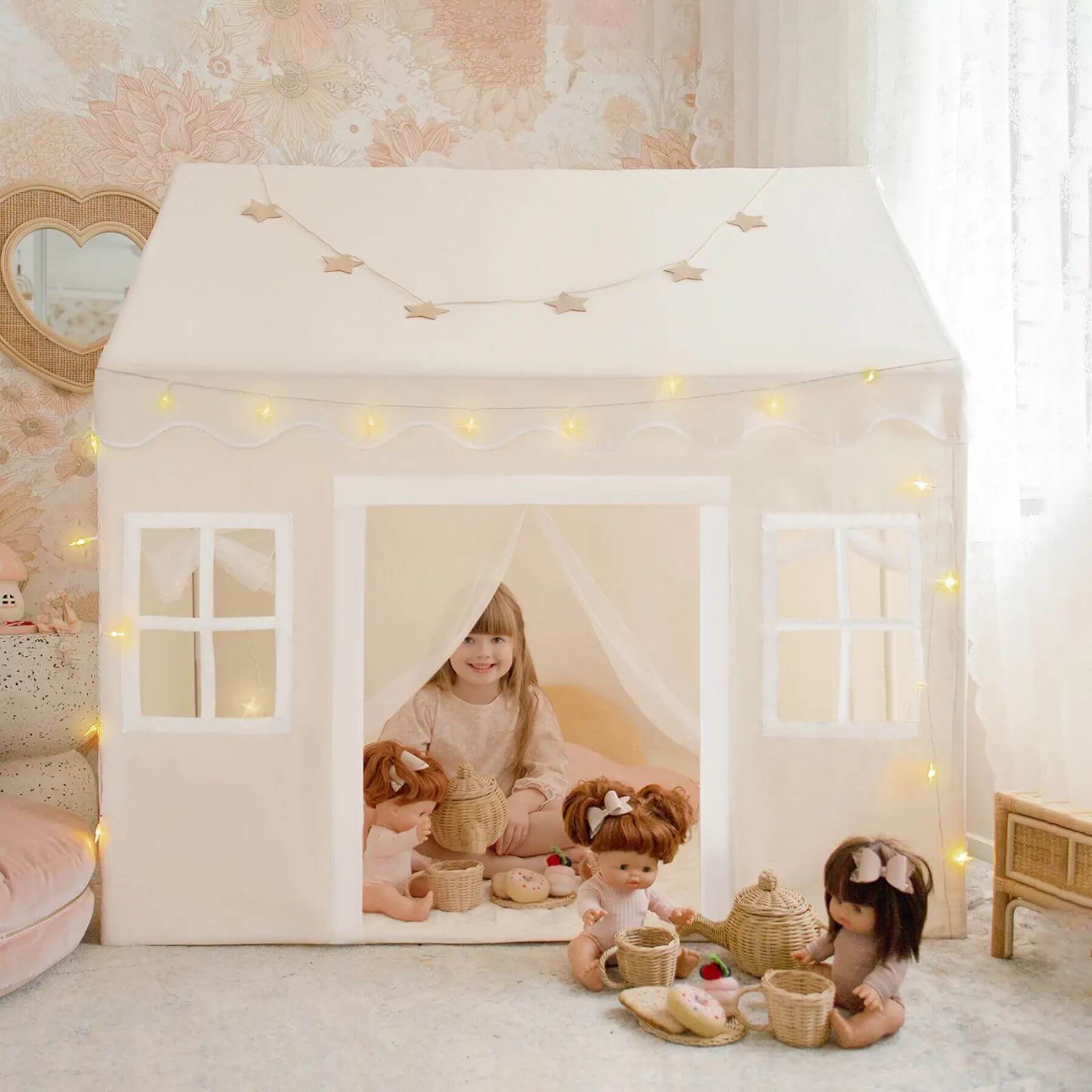Children playing with dolls inside Tiny Land® Playhouse Tent – Natural Cream in a cozy room.