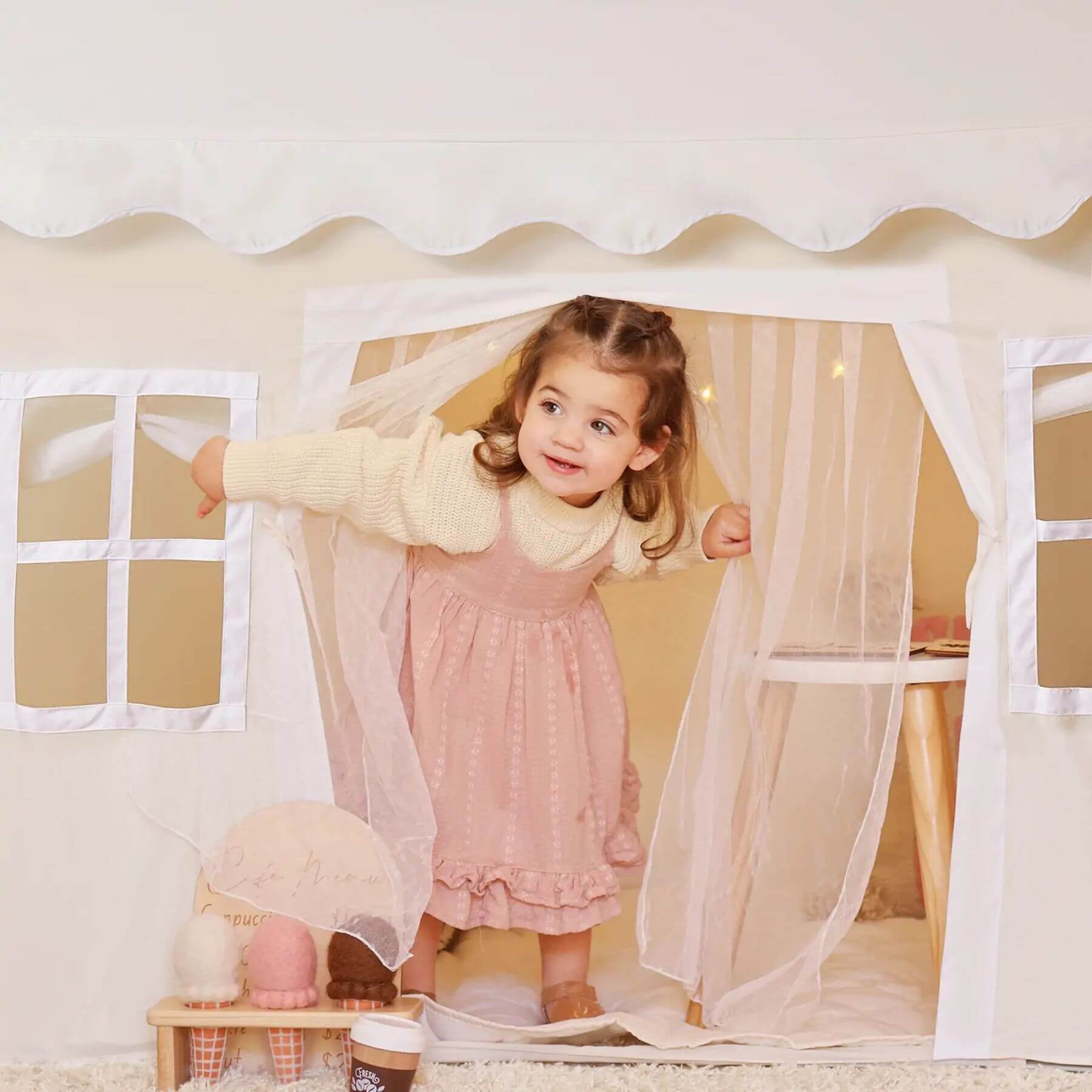 Child playing inside Tiny Land® Playhouse Tent – Natural Cream