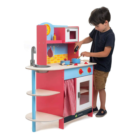 Child playing with Tender Leaf Grand Kitchen on a white background