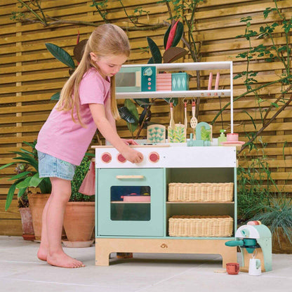 Child playing with Tender Leaf Kitchen Range outdoors