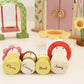 Set of wooden toy figures with names on a white surface