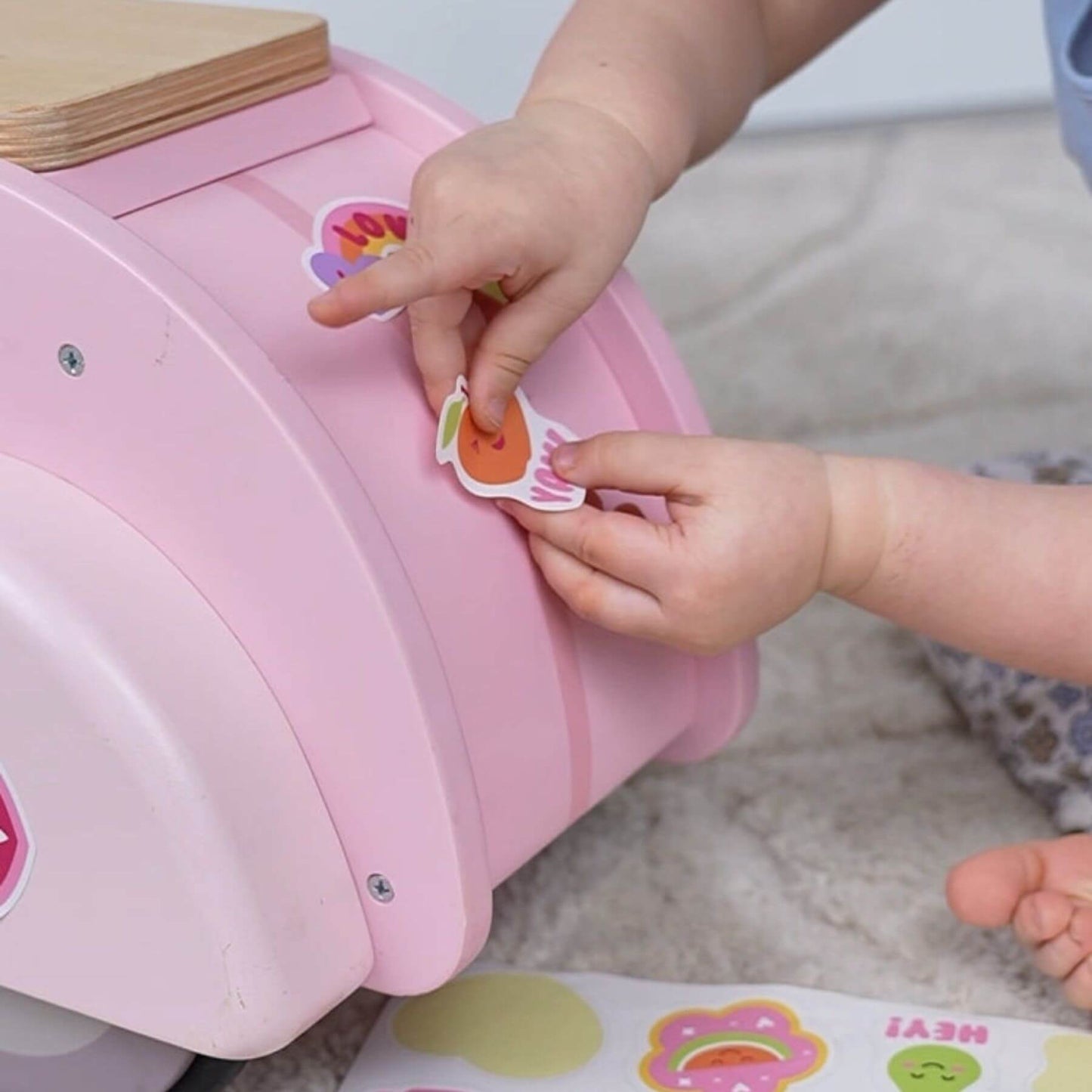 Child's hands interacting with Tender Leaf Scooter with Basket