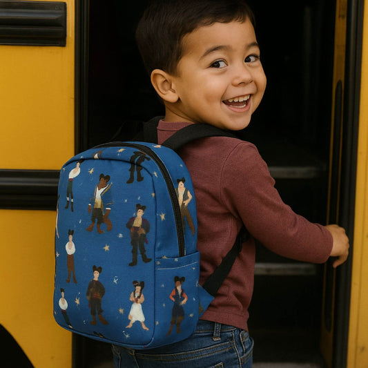 Child with Toddler Prince Magic Backpack featuring character illustrations, standing in front of a yellow vehicle.