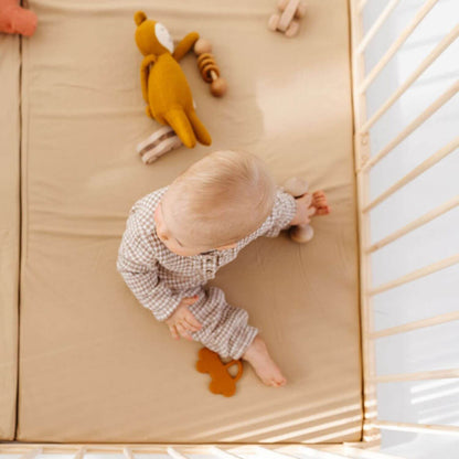 Baby playing in Toki Kids Playpen - Mega Size in Wood