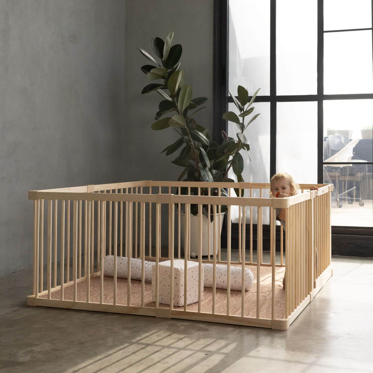 Kid playing in Toki Kids Playpen - Mega Size in Wood in living room