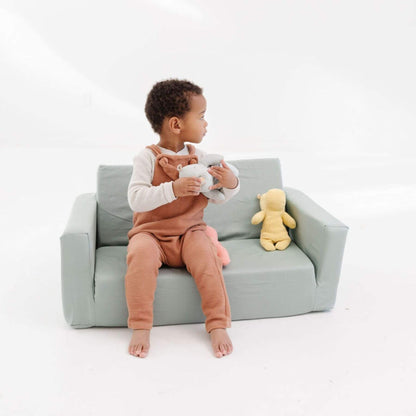 Child sitting on Toki Kids Sage Play Couch holding teddy bears