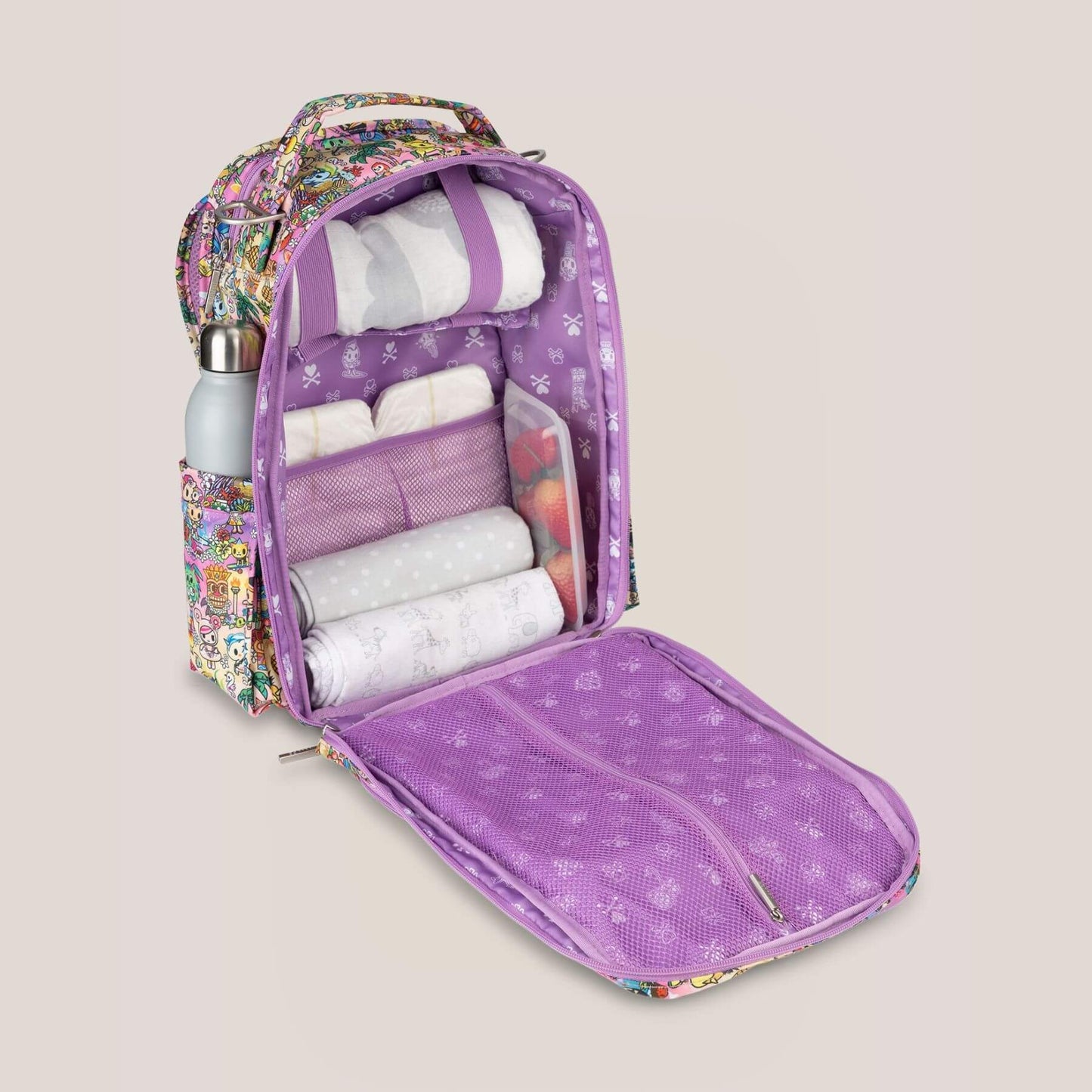 tokidoki Be Right Back Diaper Backpack open to reveal items on a beige background