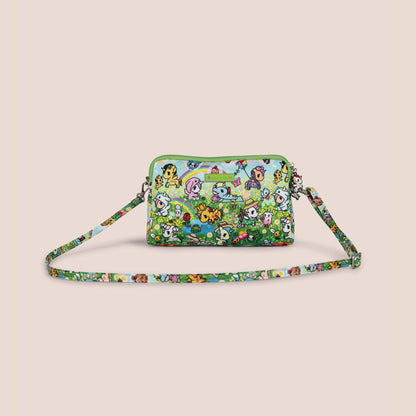 Colorful crossbody bag with character design on a beige background