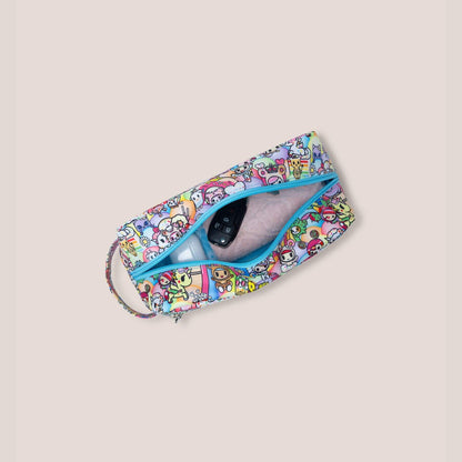 tokidoki Be Dapper Toiletry Cosmetic Pouch - 20th Anniversary Celebration with a phone inside on a beige background