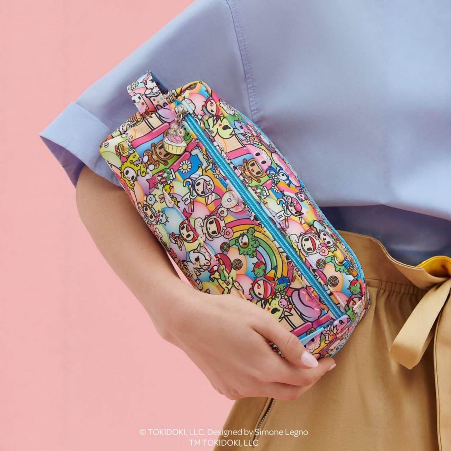 tokidoki Be Dapper Toiletry Cosmetic Pouch - 20th Anniversary Celebration held by a person against a pink background