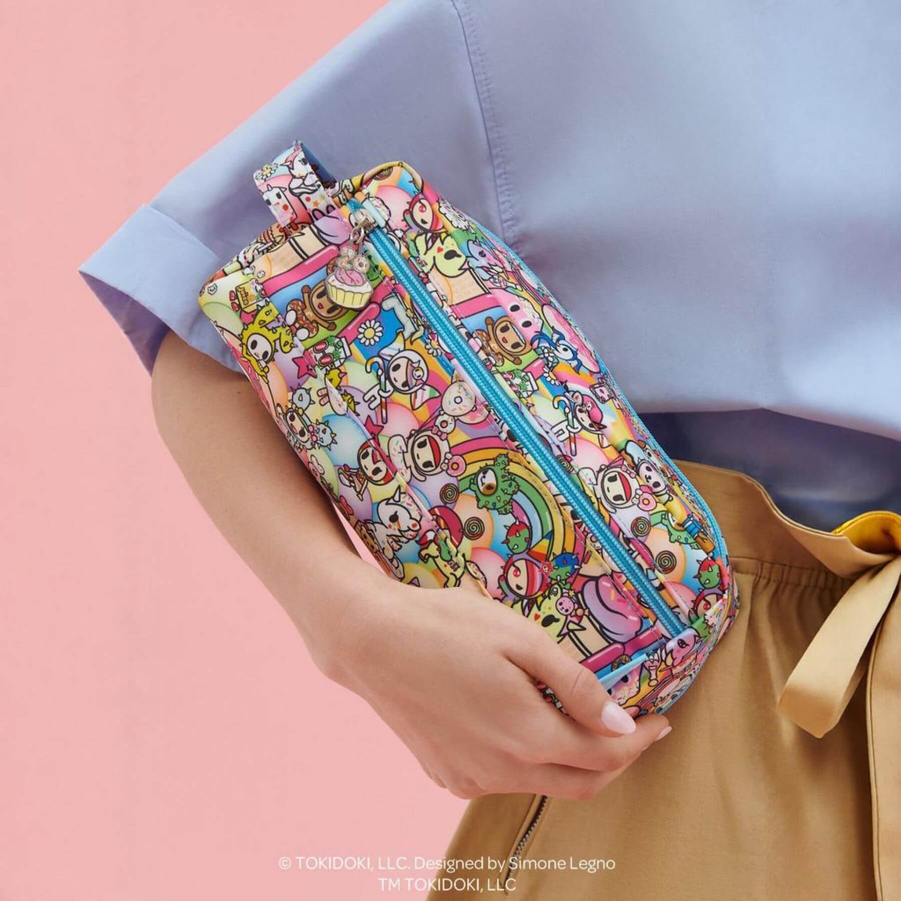 tokidoki Be Dapper Toiletry Cosmetic Pouch - 20th Anniversary Celebration held by a person against a pink background