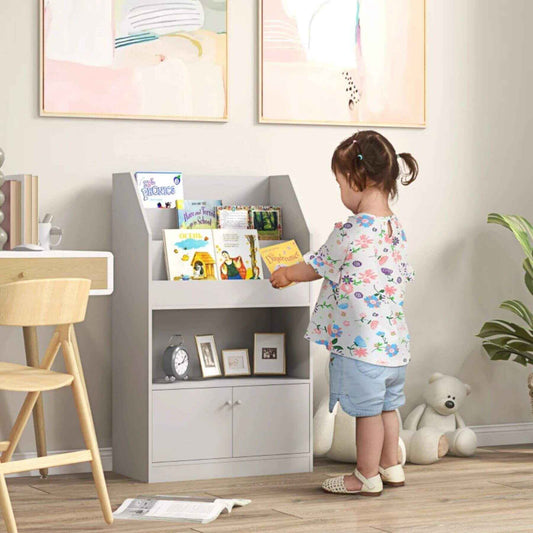 Girl Putting a Book on Qaba Toy Storage Cabinet Grey