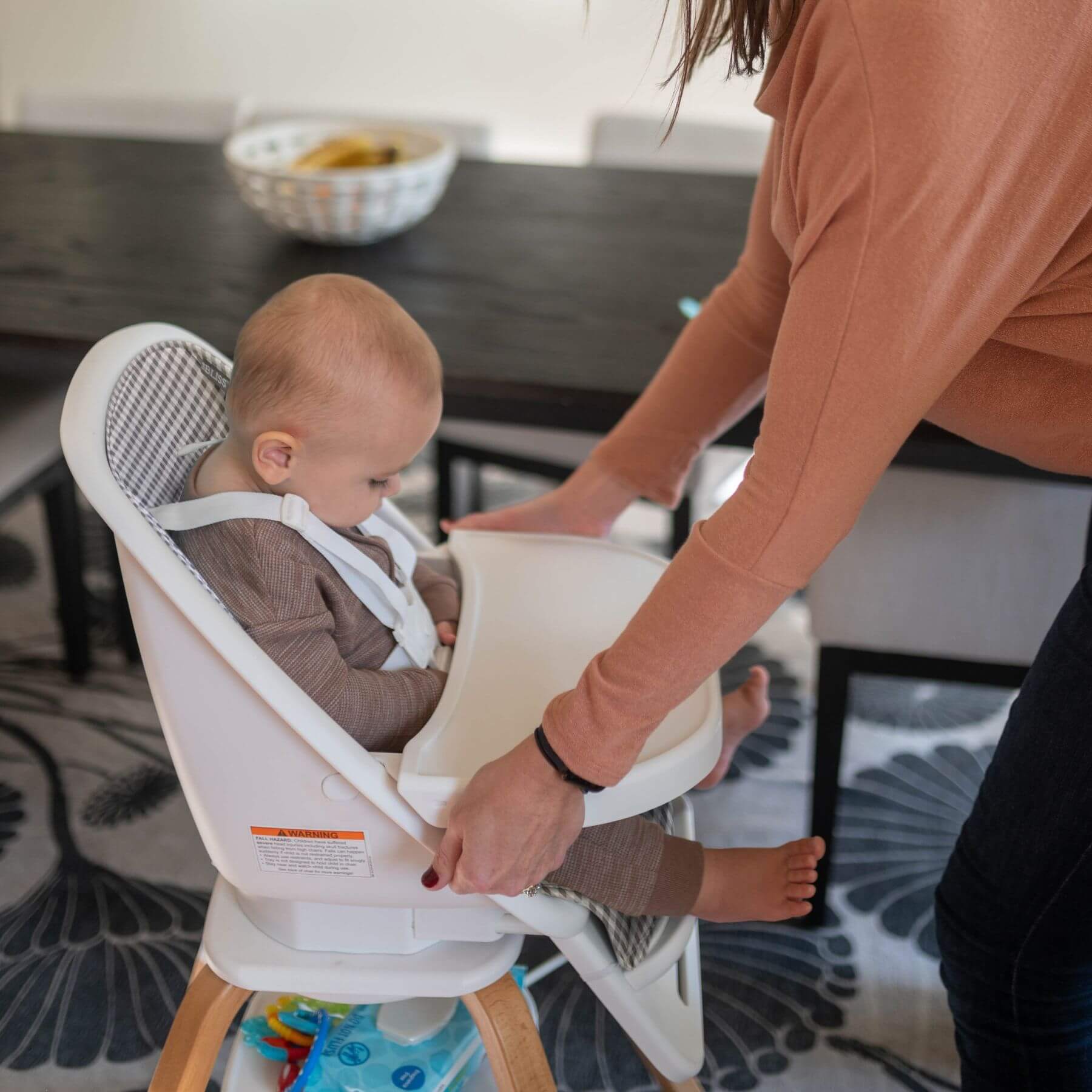 Mom Setting up TruBliss 2-in-1 Turn-A-Tot Highchair with 360° Swivel Gingham for Baby