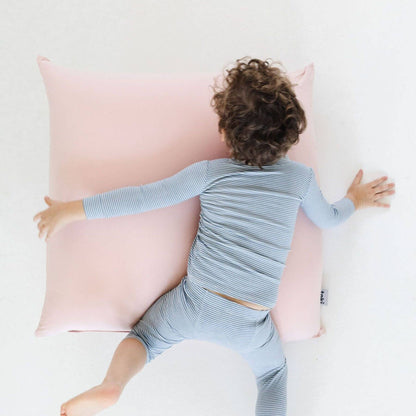 A child lies on their chest on Toki Kids Tutu Bean Bag