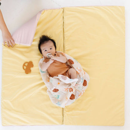 Baby lying on Toki Kids Tutu + Daisy Organic Cotton Mat